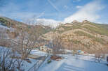 Mountain view home with snow covered landscape.
