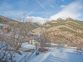 Mountain view home with snow covered landscape.