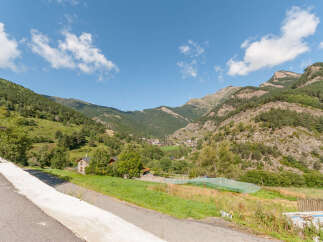 Mountain view home with large green space.
