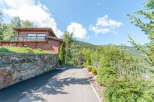 Mountain view chalet with private driveway and landscaped gardens.