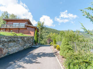 Mountain view chalet with private driveway and landscaped gardens.