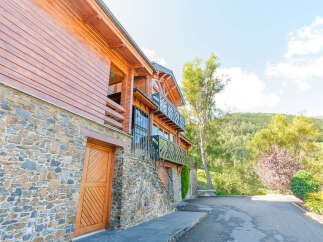 This stunning chalet boasts a unique blend of wood and stone, creating a cozy yet modern aesthetic.