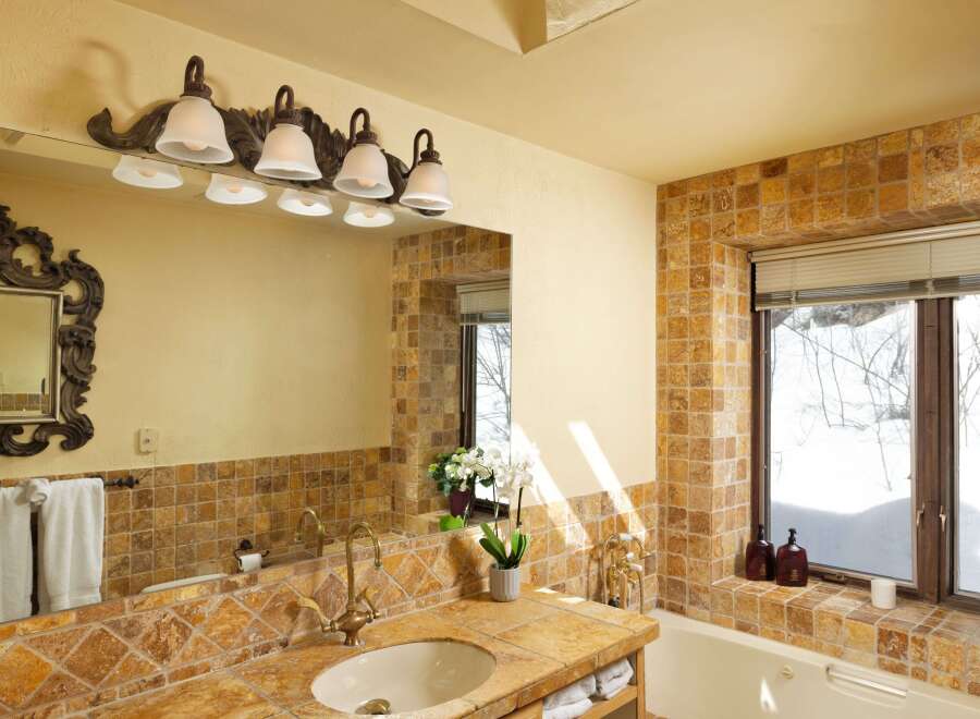 This luxurious bathroom boasts a spacious design with a large soaking tub and a double vanity with plenty of storage.