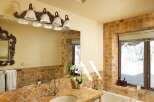 This luxurious bathroom boasts a spacious design with a large soaking tub and a double vanity with plenty of storage.