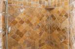 This luxurious bathroom boasts a stunning tiled shower with a built-in seat, perfect for relaxation.