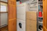 This cozy laundry room features a stackable washer and dryer set, perfect for a small space.