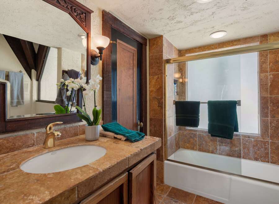 This charming bathroom boasts a unique blend of rustic and modern design.