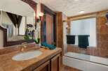 This charming bathroom boasts a unique blend of rustic and modern design.