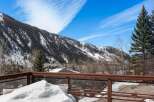 This stunning property boasts breathtaking views of snow-capped mountains and a lush forest, offering a serene escape in a picturesque setting.