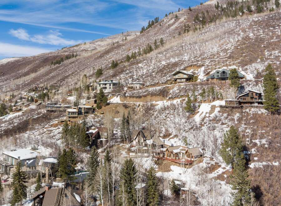 Luxury homes nestled on a snow-dusted mountainside, offering breathtaking views and privacy.