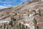 Luxury homes nestled on a snow-dusted mountainside, offering breathtaking views and privacy.