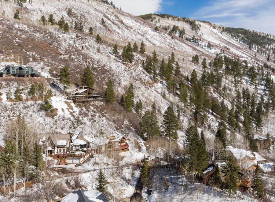 Luxury homes nestled on a snow-covered mountainside, offering breathtaking views and privacy.