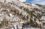 Luxury homes nestled on a snow-covered mountainside, offering breathtaking views and privacy.