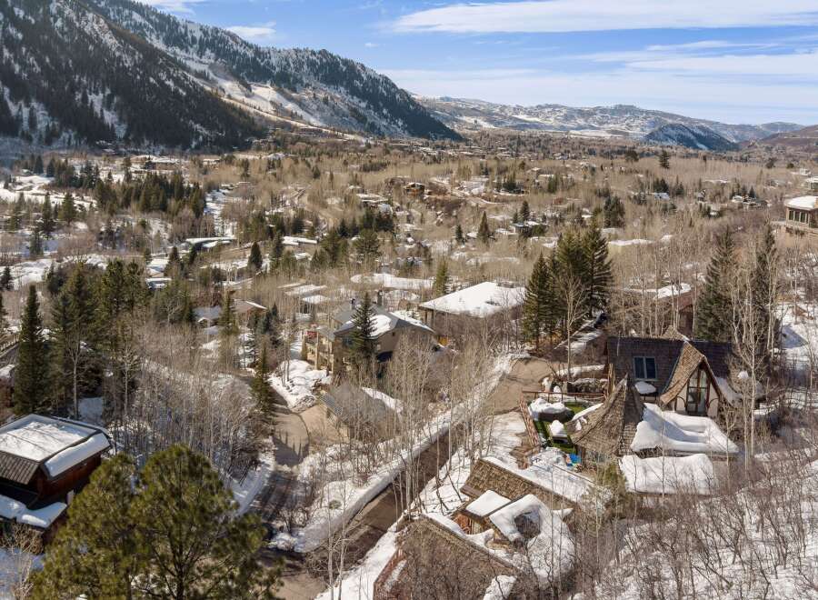 This stunning property boasts a unique architectural design, nestled in a picturesque snowy mountain setting.