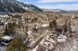 This stunning property boasts a unique architectural design, nestled in a picturesque snowy mountain setting.