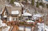 This stunning mountain home boasts a unique architectural design with a charming, fairytale-like aesthetic.
