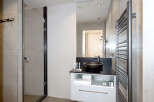 Modern bathroom with a sleek black sink and a frameless glass shower enclosure.