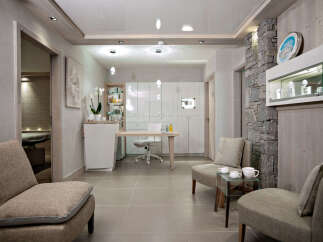 This luxurious spa boasts a serene waiting area with comfortable seating, a sleek reception desk, and modern white cabinetry.
