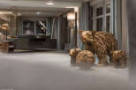 This stunning hotel lobby features unique driftwood sculptures of bears and cubs, adding a touch of rustic charm.