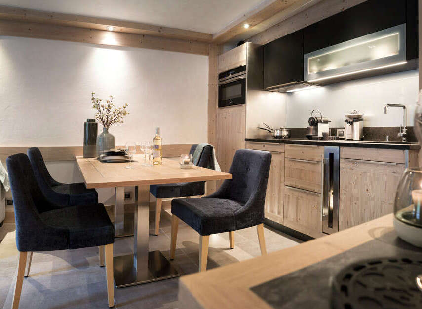 This stunning apartment boasts a modern, fully equipped kitchen with sleek cabinetry and high-end appliances.