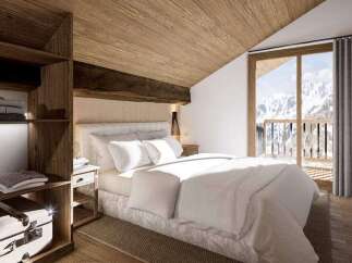 Cozy chalet bedroom with wooden accents and mountain views.