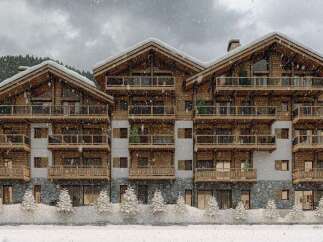Luxury chalet-style apartments in a stunning snowy mountain setting.