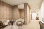 Relax in style in this serene waiting area, featuring a calming wood design and plush seating.