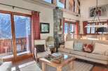 This stunning chalet boasts breathtaking mountain views, floor-to-ceiling windows, and a spacious living area perfect for relaxation.
