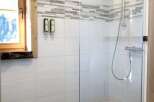 Step into a modern bathroom oasis with a sleek glass shower enclosure.