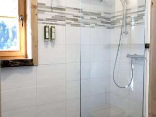 Step into a modern bathroom oasis with a sleek glass shower enclosure.