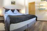 This cozy bedroom features a comfortable bed with a stylish headboard and soft bedding, perfect for a relaxing stay.
