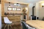 This charming kitchen features a rustic wooden island and a cozy dining area, perfect for entertaining.