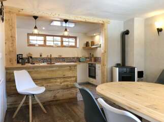 This charming kitchen features a rustic wooden island and a cozy dining area, perfect for entertaining.