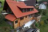 Discover a charming wooden house nestled in a picturesque setting.