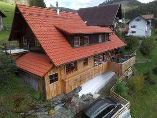 Discover a charming wooden house nestled in a picturesque setting.