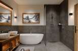 This luxurious bathroom features a modern design with a touch of rustic charm.