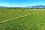 This expansive property boasts lush green pastures, ideal for grazing livestock or hay production.
