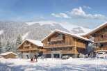 Discover luxury living in this stunning chalet, nestled in a picturesque snowy landscape.
