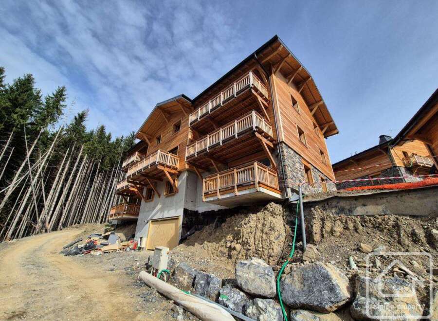 Discover this stunning wooden chalet nestled in a picturesque mountain setting.