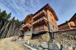 Discover this stunning wooden chalet nestled in a picturesque mountain setting.