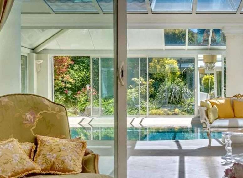 Luxurious villa with a stunning indoor pool and conservatory.