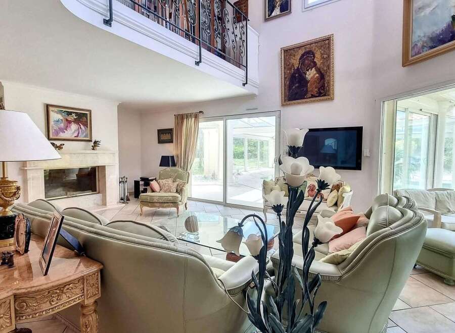 Luxurious living room with high ceilings and large windows offering ample natural light.