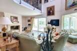 Luxurious living room with high ceilings and large windows offering ample natural light.