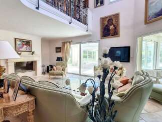 Luxurious living room with high ceilings and large windows offering ample natural light.