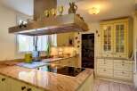This stunning kitchen boasts granite countertops and custom cabinetry, creating a bright and airy atmosphere.