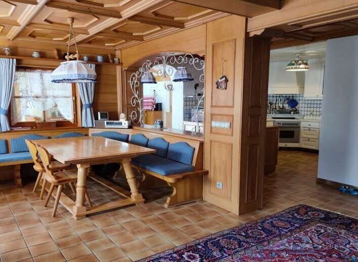 Step into a charming dining area with a rustic wooden table and benches, perfect for family gatherings.