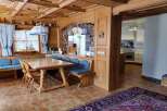 Step into a charming dining area with a rustic wooden table and benches, perfect for family gatherings.
