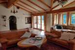 Experience the charm of this inviting living space, featuring a cozy seating area and a warm, inviting atmosphere.