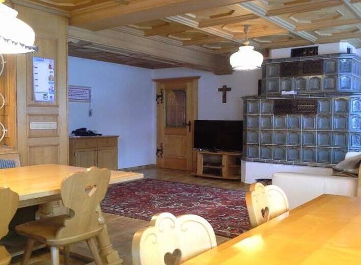 Experience the charm of this cozy property, featuring a traditional wooden interior and a unique tiled stove.