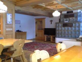 Experience the charm of this cozy property, featuring a traditional wooden interior and a unique tiled stove.